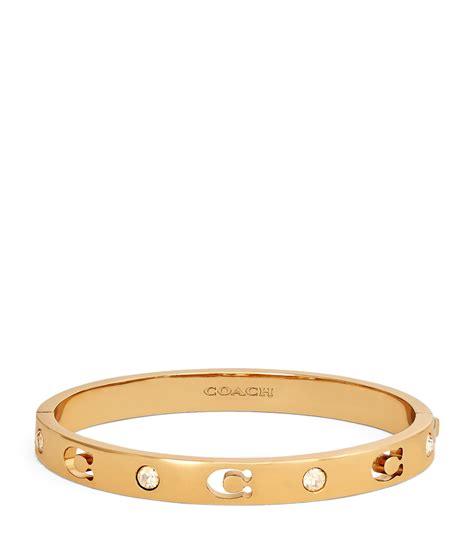 coach signature hinged bangle.